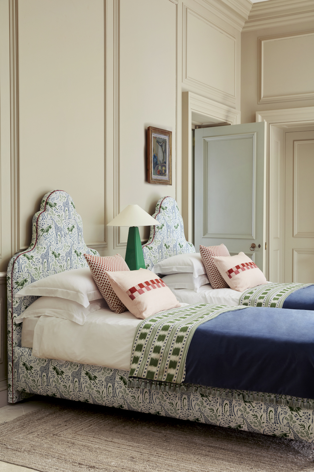 Image of two single beds with matching upholstered headboards.